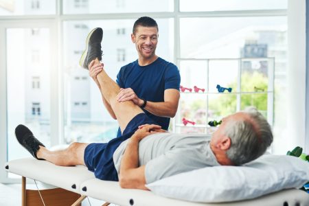 Cropped shot of a handsome young male physiotherapist doing a consultation and assessment with a senior patient